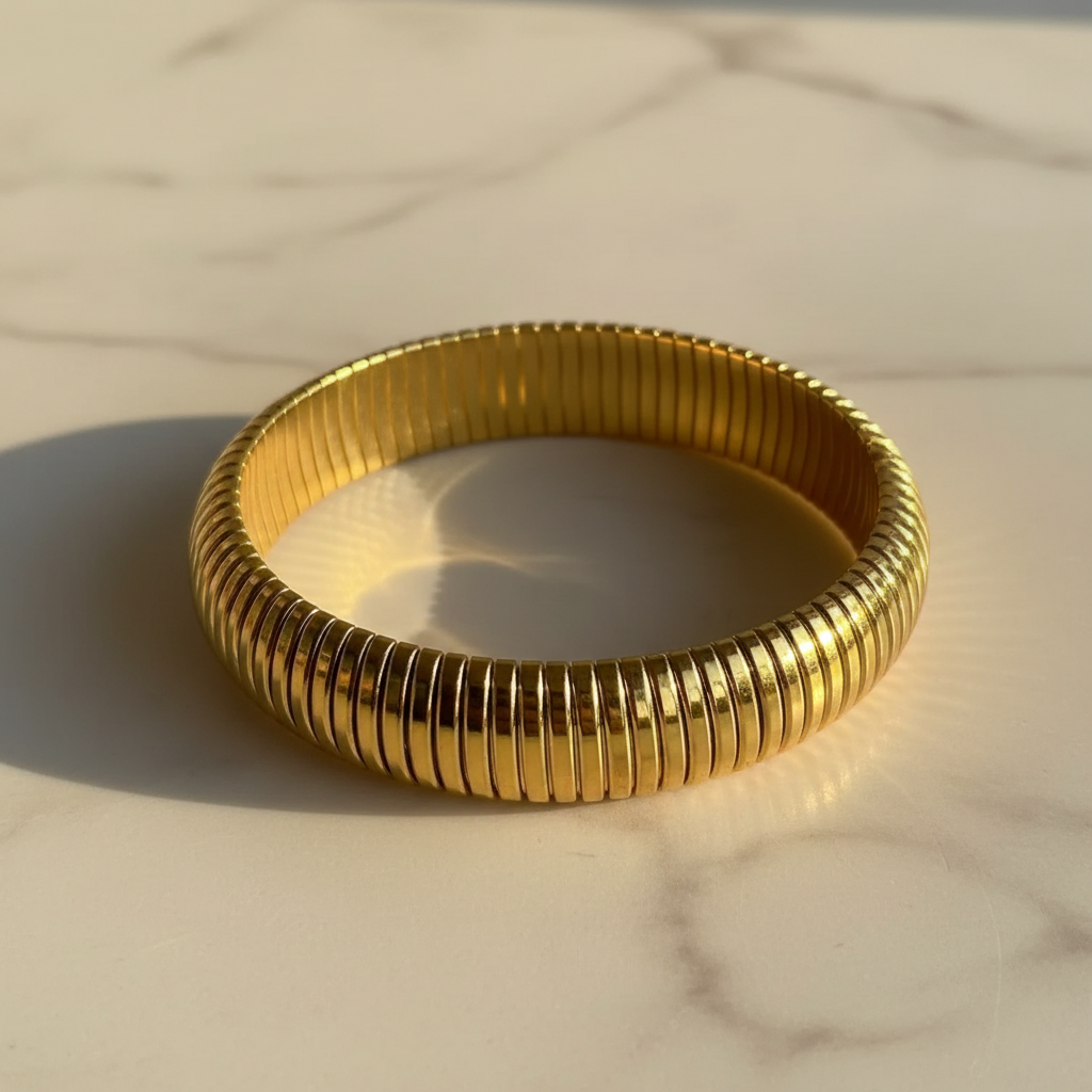 Golden Hour Ribbed Coil Bangle 16mm – side angle marble surface