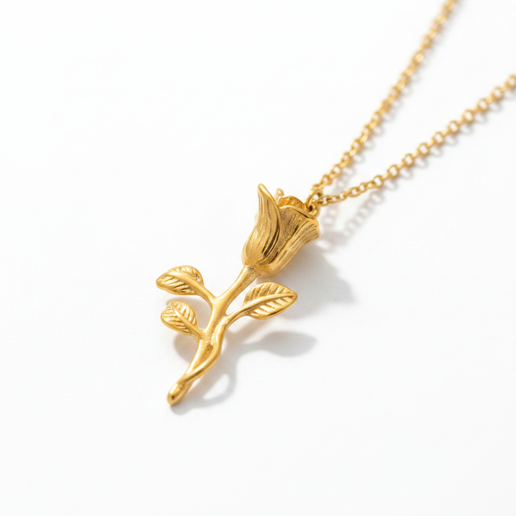 Close-up of 3D carved gold rose pendant on stainless steel chain